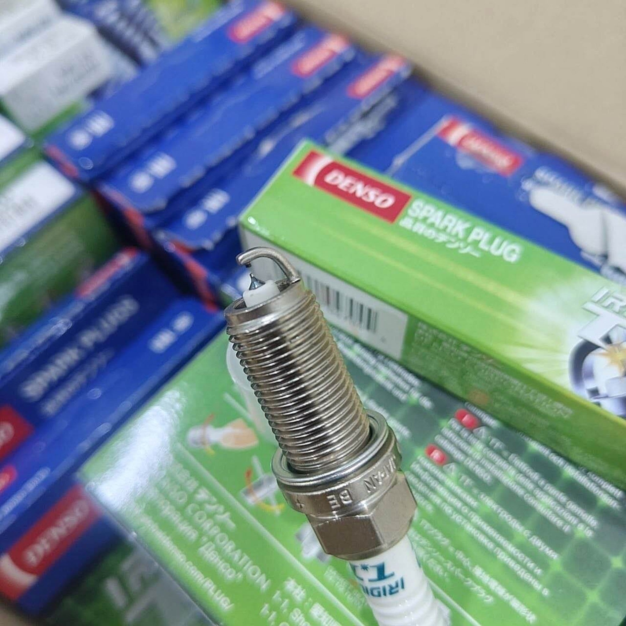 BANQIU Cambodia Co.,Ltd. 出售的 DENSO Iridium TT 高性能汽车火花塞，采用双针技术，包装盒背景清晰可见。